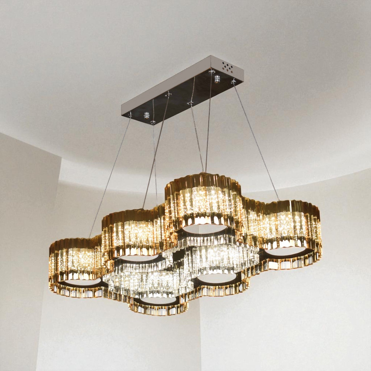 Chandelier hanging from the ceiling in a room with white walls.