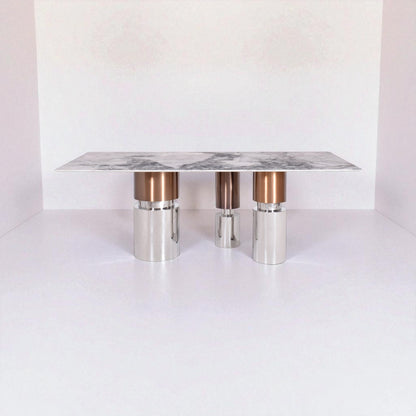 Modern coffee table with marble top and metallic legs on a white background