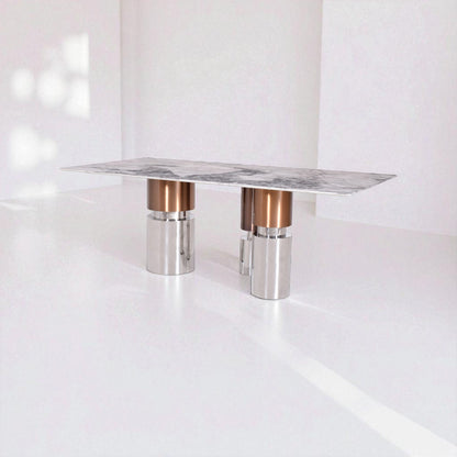 Modern table with marble top and metallic legs on a white background