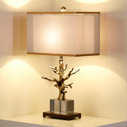 Decorative table lamp with a unique branch-like design on a neutral background