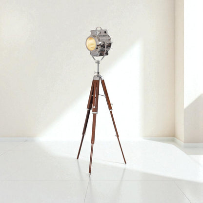 Vintage-style floor lamp with wooden tripod base on a white background