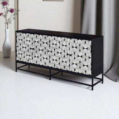 Black and white patterned sideboard in a room with a vase and curtain.