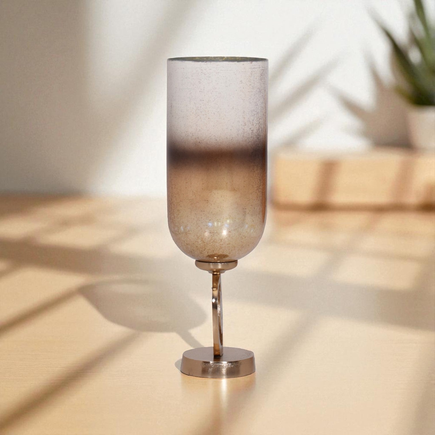 Decorative glass lamp with a textured shade on a reflective surface