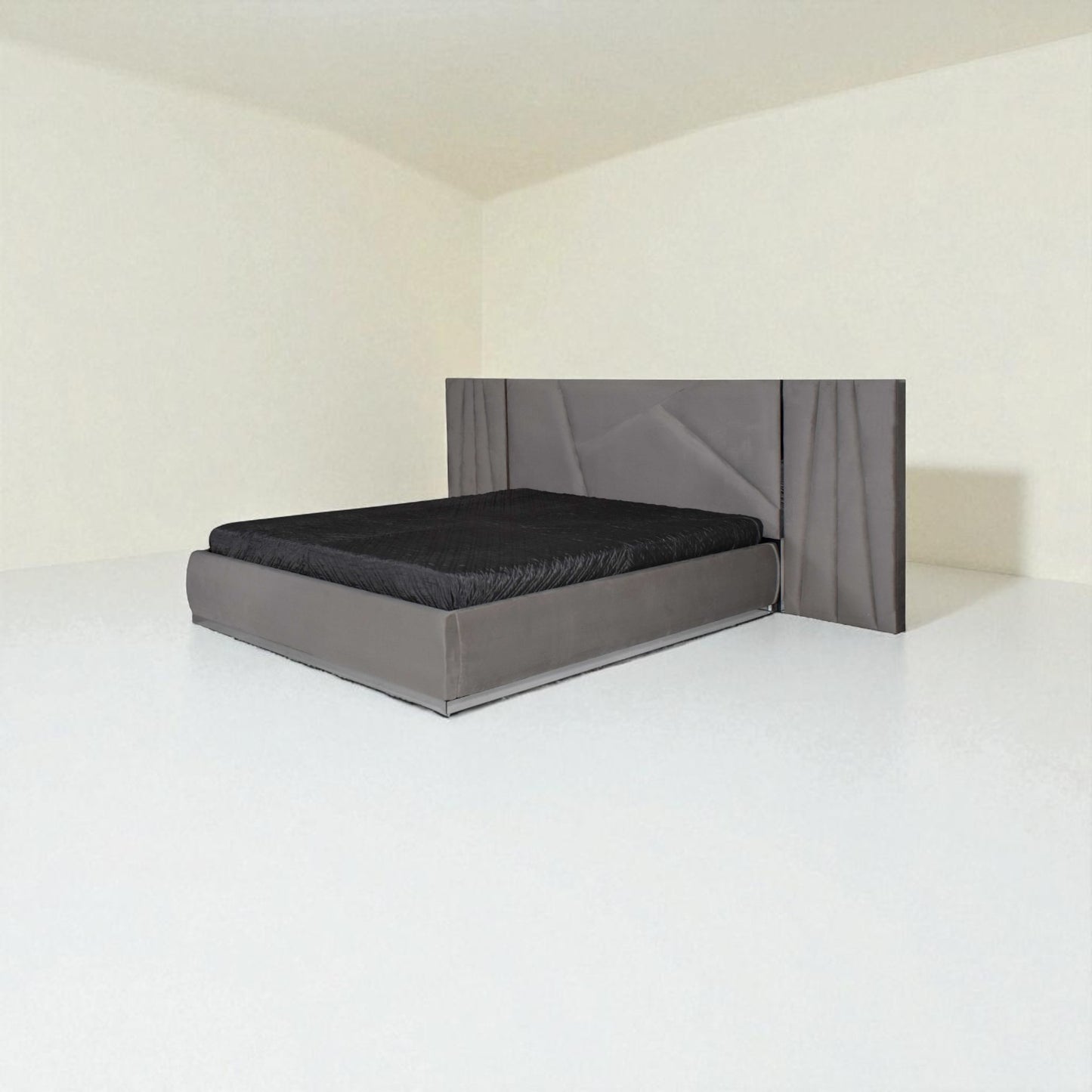 Modern grey bed with a geometric-patterned headboard and black bedding in a minimalist room.