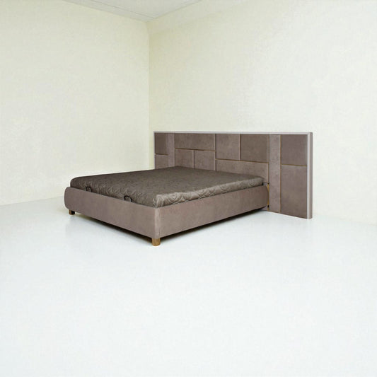 Gray upholstered bed with geometric headboard in a minimalistic room.