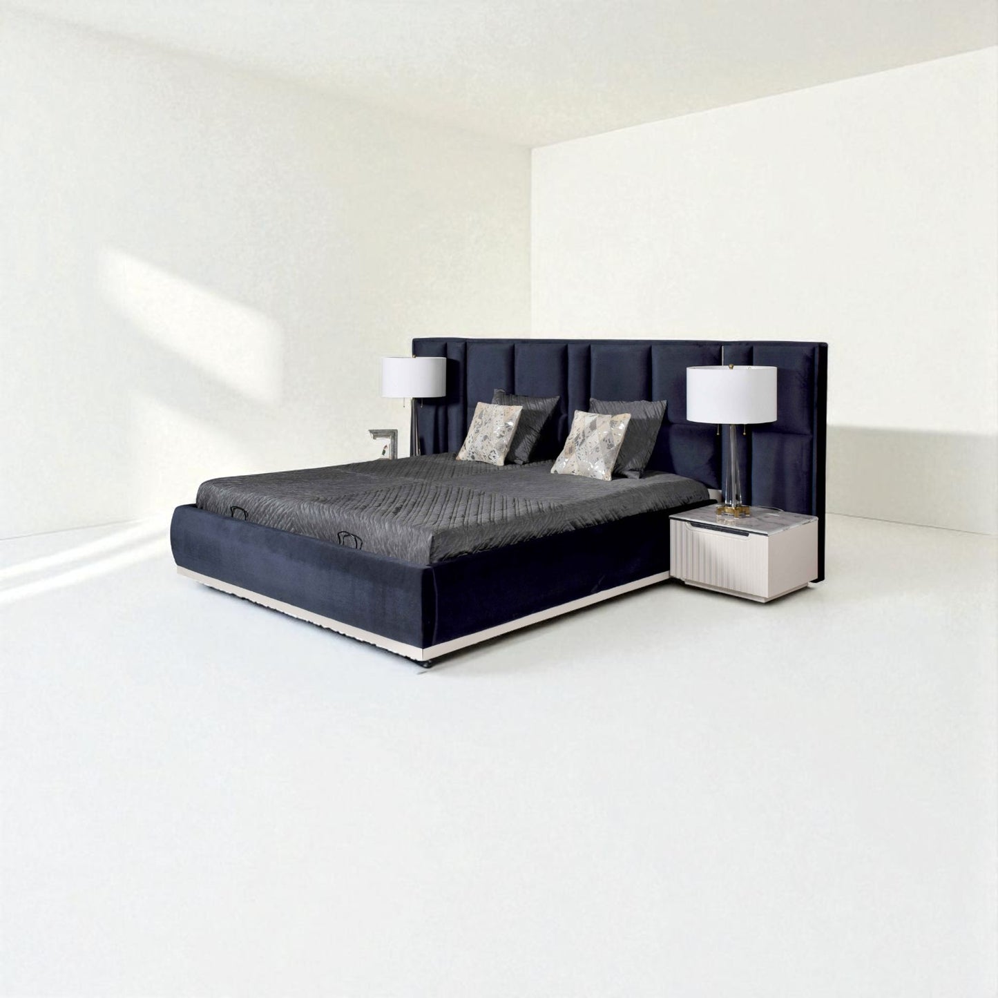 Modern dark blue bed with a tall tufted headboard, gray bedding, decorative pillows, and matching bedside tables with lamps in a minimalist room.
