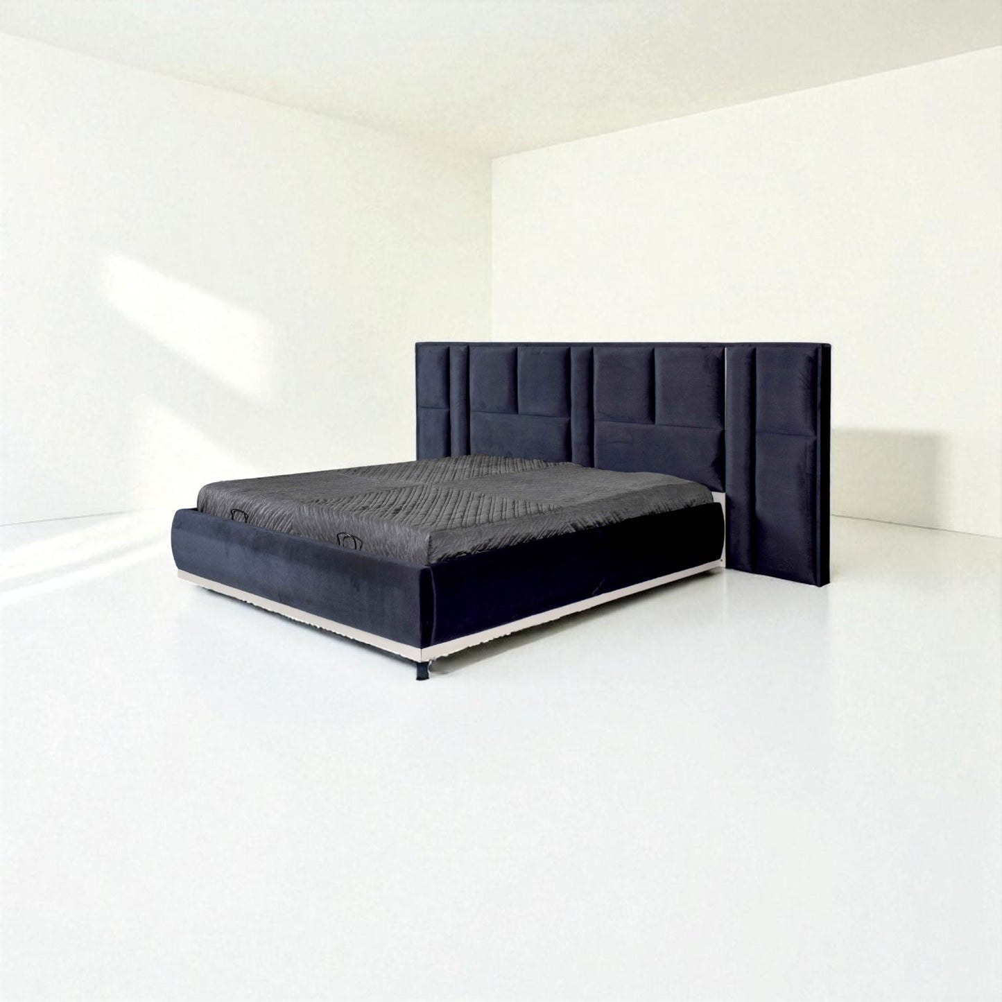 Dark blue bed with a tall panel headboard and gray bedding, set in a minimal white room.