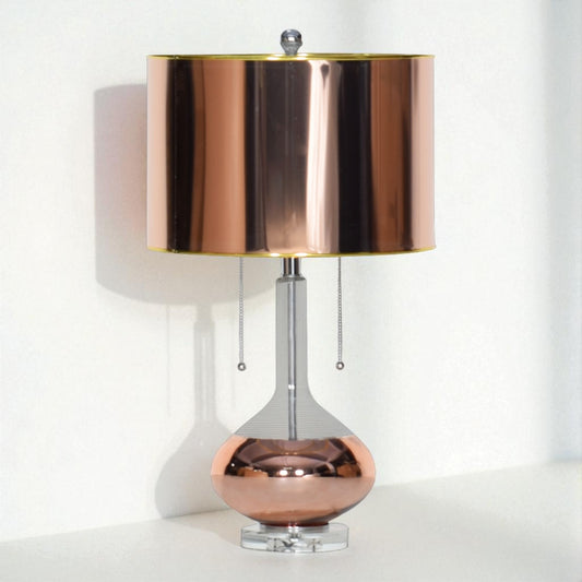 Table lamp with a copper-colored shade and base on a white background