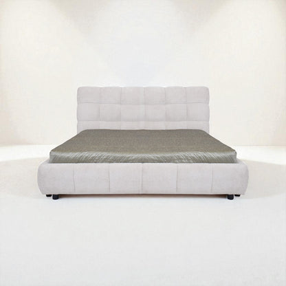 Gray upholstered bed with mattress on a white background