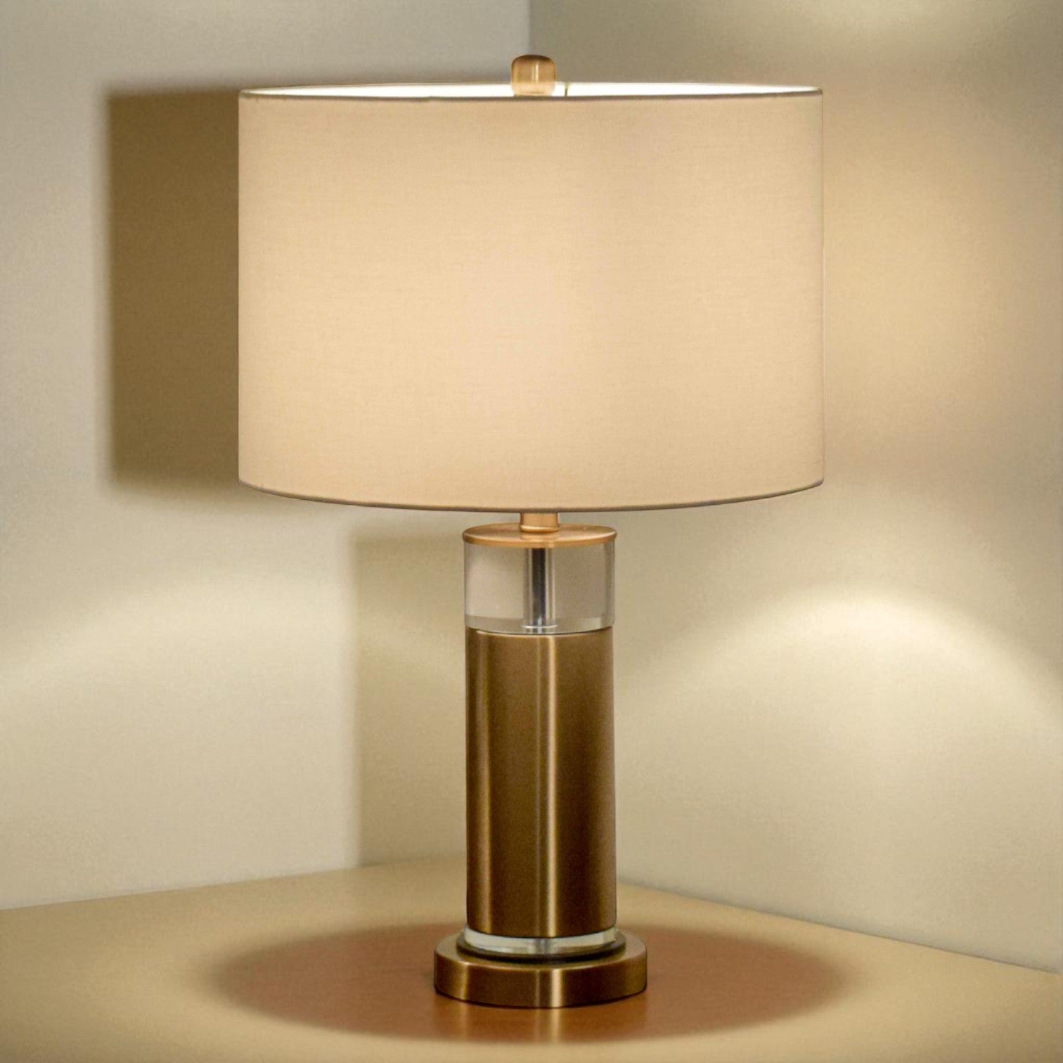 Table lamp with beige shade and bronze base on a neutral background