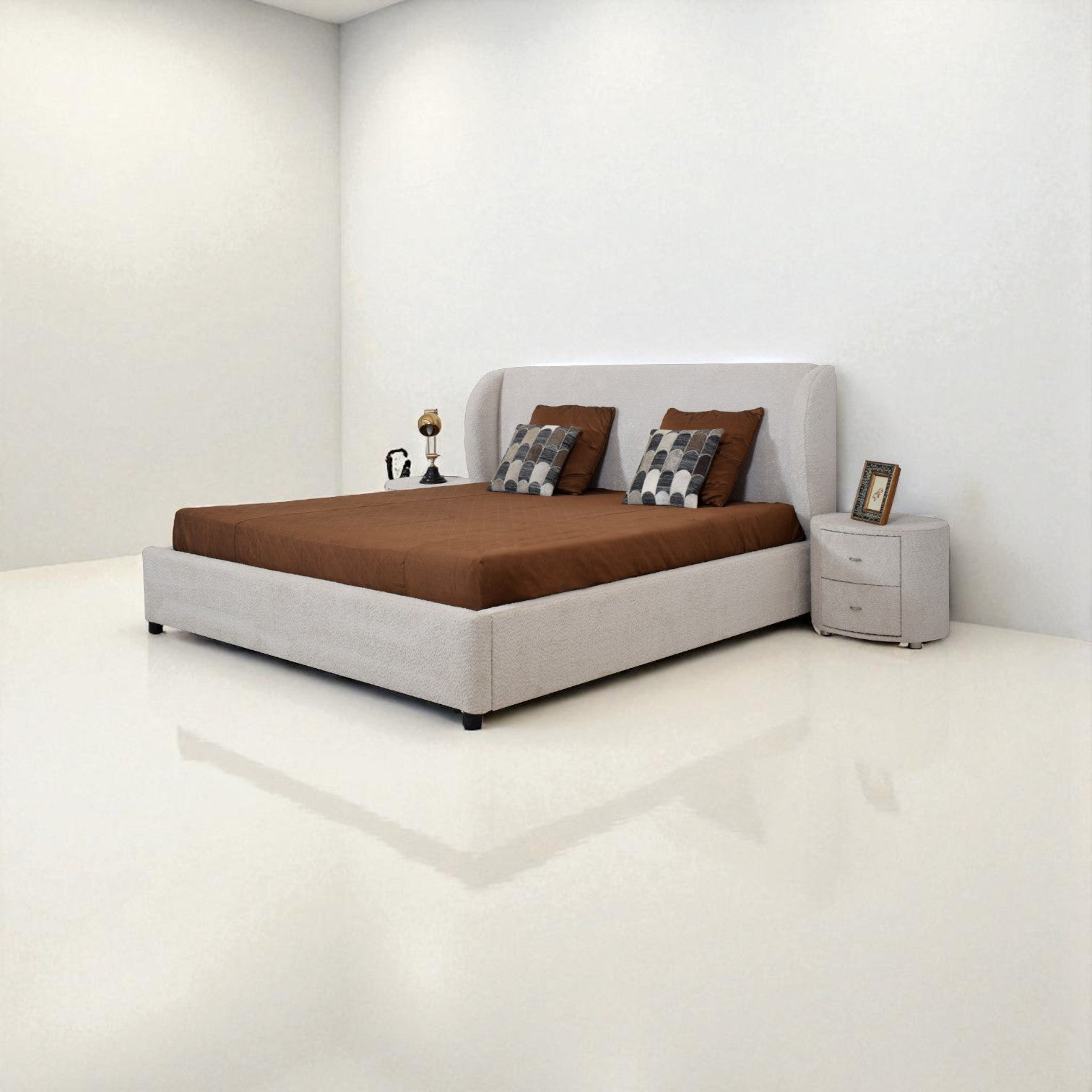 Bedroom with a bed, nightstand, and decorative items on a white floor and walls.