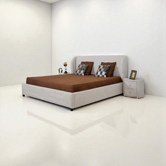 Bedroom with a bed, nightstand, and decorative items on a white floor and walls.