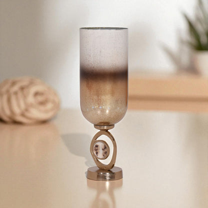 Decorative lamp with a textured glass shade on a reflective surface