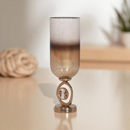 Decorative lamp with a textured glass shade on a reflective surface