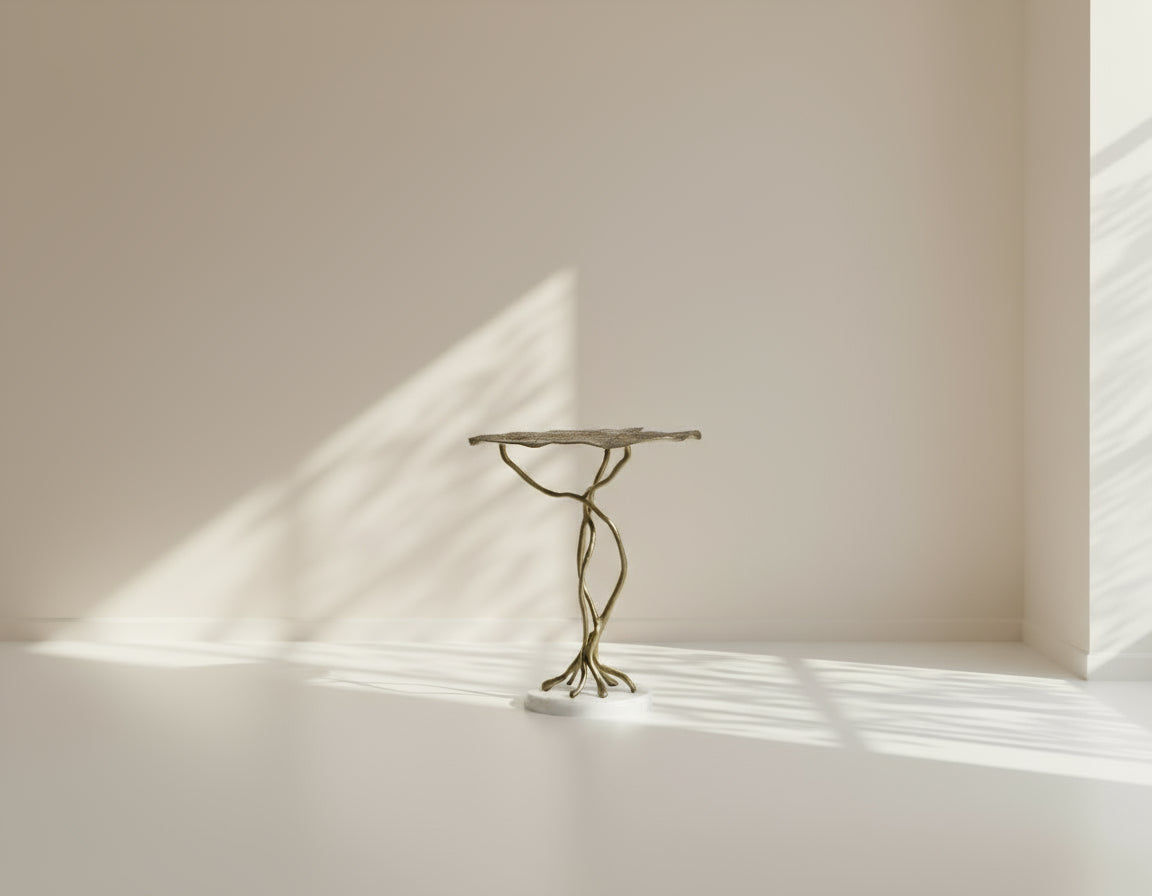 End table with leaf motif in an antique gold-finished aluminum with marble base.