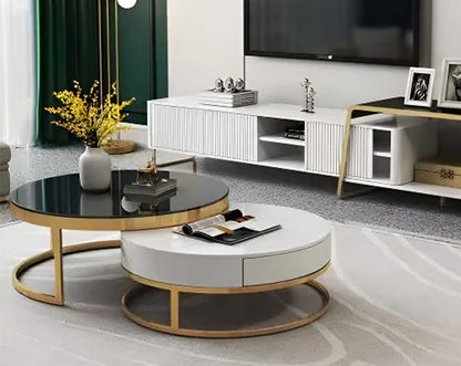 This round coffee table set is an embodiment of modern glamour. One comes with a black tempered glass top and the other in a glossy white wood top with drawer living room The base is in a shiny fingerless gold plated stainless steel finish in geometric de