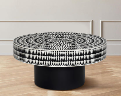 This gorgeous black and white inlay coffee table with a black metal base is a perfect statement piece in your living room.
