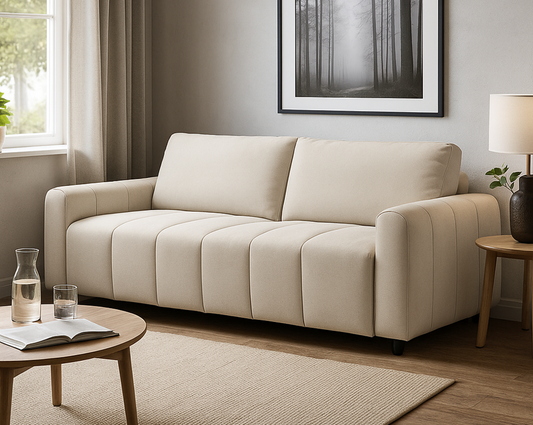 Beige sofa in a living room with a coffee table, lamp, and framed picture on the wall.